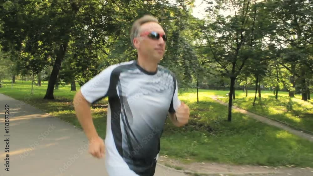 The man likes to run in the park, for a healthy lifestyle The man likes to run in the park, for a healthy lifestyle