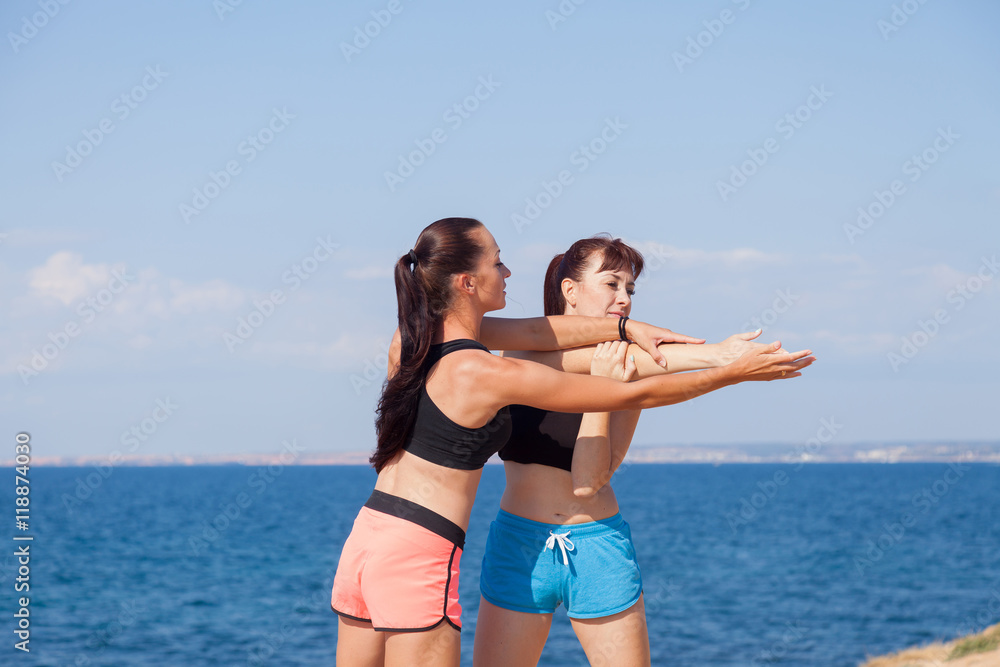 trainer helps the girl to do the exercises trainer helps the girl to do the exercises