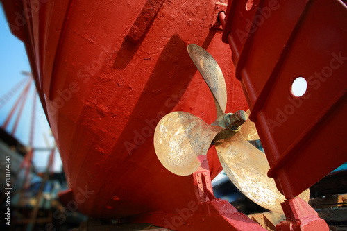 Lower part of stern and propeller of a fishing boat in a shipyard.