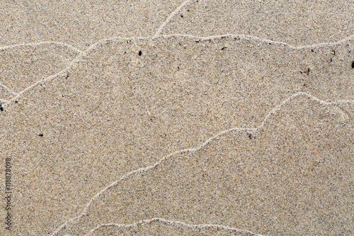 Abstract pattern of waves on a sandy beach