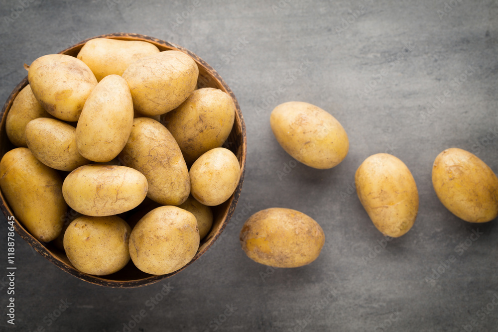 New potato on the bowl, gray background. New potato on the bowl, gray background.