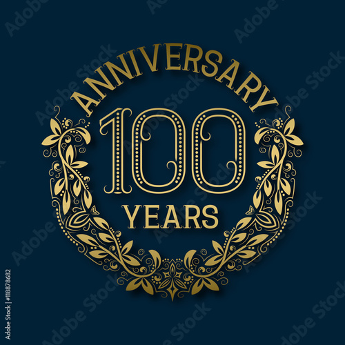 Golden emblem of hundredth years anniversary. Celebration patterned logotype with shadow on blue.