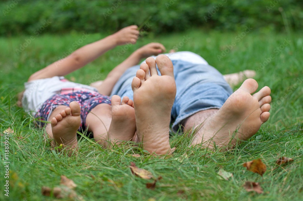Dad and daughter lying on green grass Dad and daughter lying on green grass