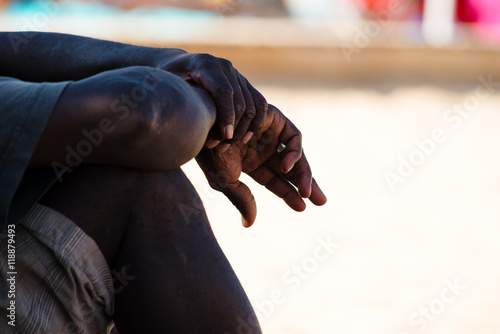 black man resting, hands detail, immigration and integration concept photo