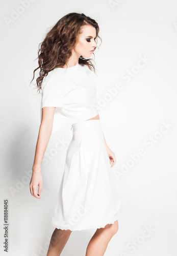beautiful woman model posing in white dress in the studio