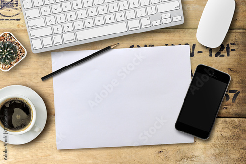 business desk with a keyboard, mouse and pen on wooden table with space for text. over light