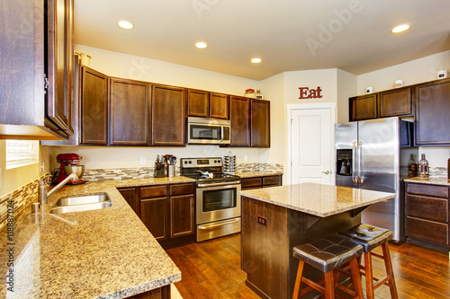 Kitchen room interior with deep brown cabinets  hardwood floor