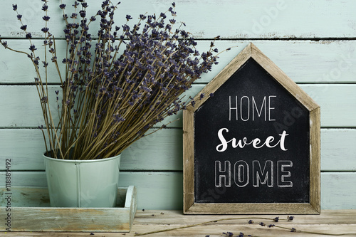 text home sweet home in a house-shaped signboard photo