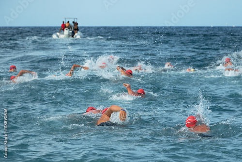 Group people in wetsuit swimming at sea