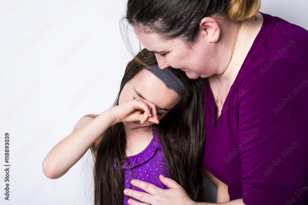 mother comforting her daughter