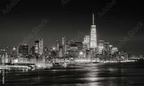 Skyscrapers of New York City Financial District illuminated at night. Aerial panoramic view of Lower Manhattan and the Hudson River in Black & White © Francois Roux