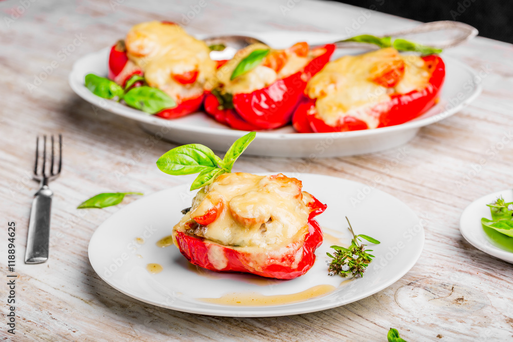Stuffed peppers with meat and cheese on white plate