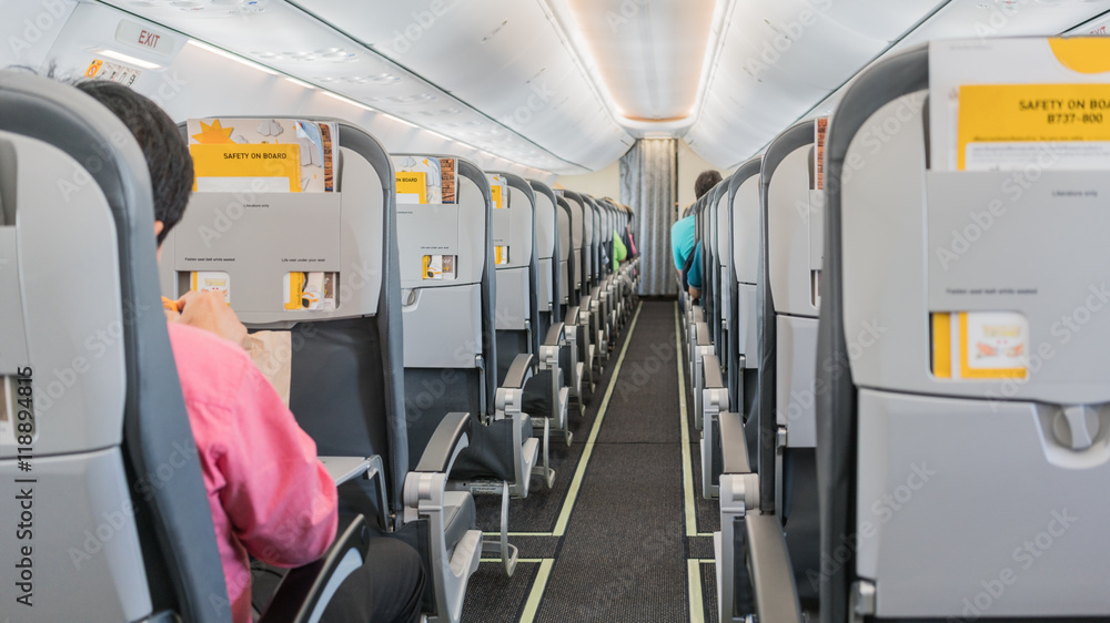 Fototapeta premium Passengers seated in the plane's cabin before plane taking off