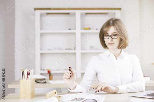 Pretty businesswoman doing paperwork