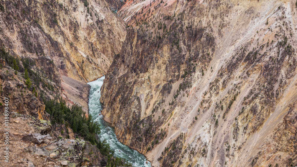 Obraz premium Stormy river flows in a narrow gorge in the rocks. Mountain landscape. Point sublime on the Grand Canyon of the Yellowstone, Yellowstone National Park, Wyoming