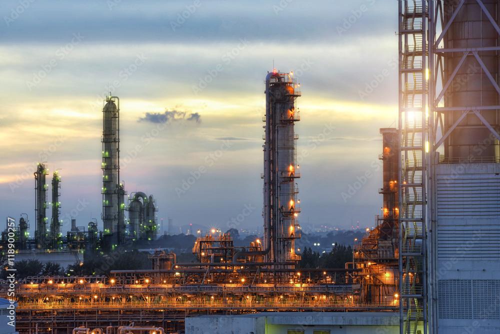 Fototapeta premium Refinery plant at beautiful clouds sunset.