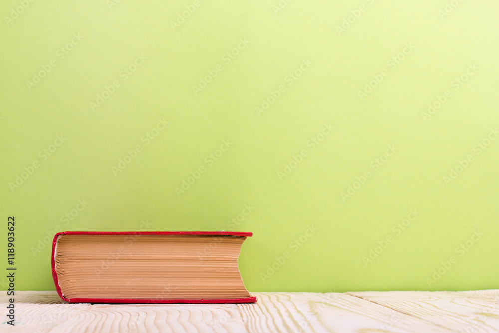 Stack of hardback books, diary on wooden deck table and green background. Back to school. Copy Space. Education background Stack of hardback books, diary on wooden deck table and green background. Back to school. Copy Space. Education background