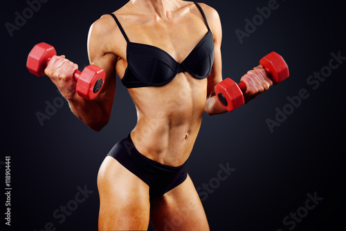 muscle woman does sports exercises © vitaliismulskyi