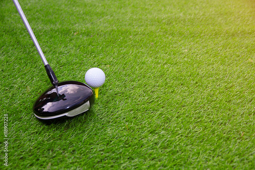 Golf club and golf ball on grass swing shot in the summer