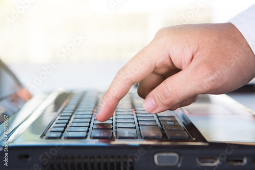 Hands of a man working with computer