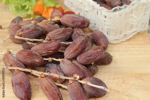 Dried date palm delicious on wood background.