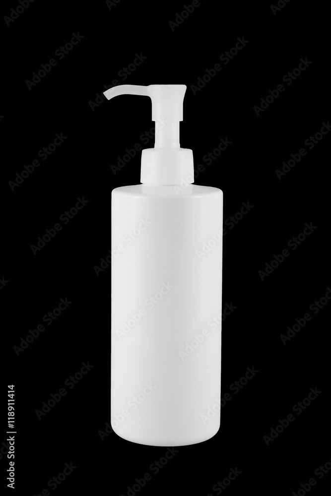 White plastic bottle with pump lid. It is isolated on black background. White plastic bottle with pump lid. It is isolated on black background.