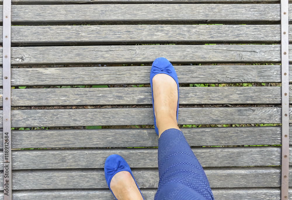 Feet in shoes on a wooden bridge. Feet in shoes on a wooden bridge.