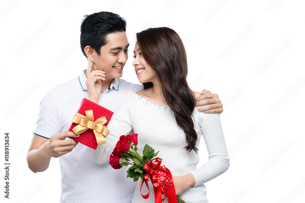 Asian man makes present to his lovely sweetheart. Young man giving a gift. Cheerful young couple man and woman at home offering to each other gifts for lover's valentine day Asian man makes present to his lovely sweetheart. Young man giving a gift. Cheerful young couple man and woman at home offering to each other gifts for lover's valentine day