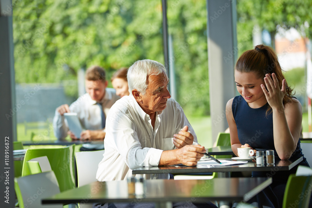 Senior businessman giving consultation to woman Senior businessman giving consultation to woman