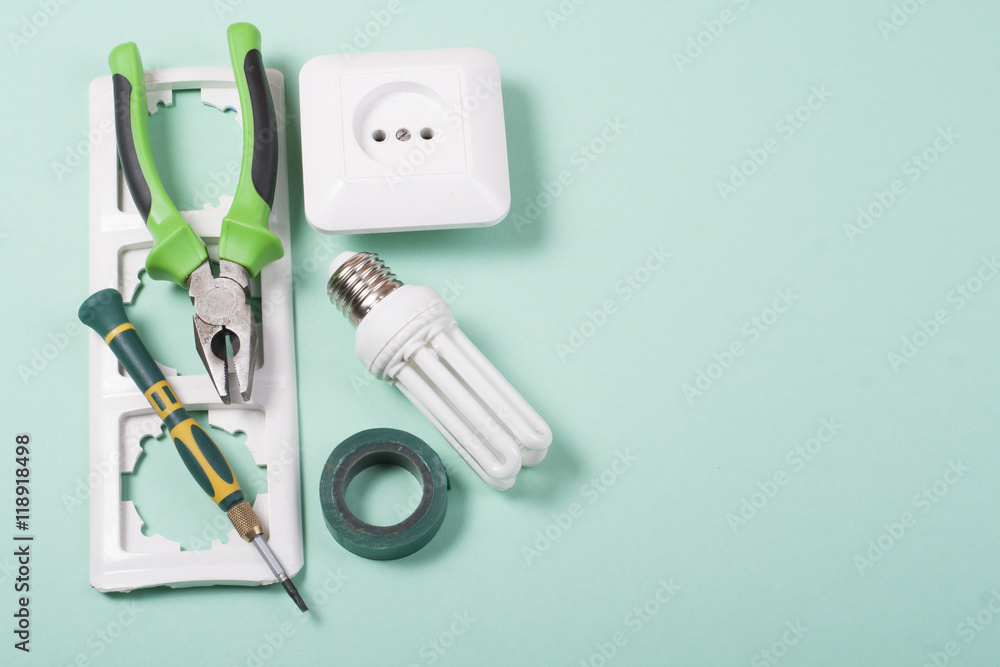 Set of electrical tool on wooden background. Accessories for engineering work, energy concept. Set of electrical tool on wooden background. Accessories for engineering work, energy concept.