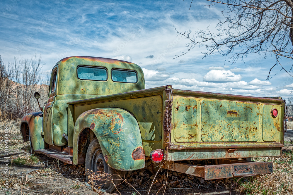 Fototapeta premium A rusted, retro pickup truck under a cloudy sky