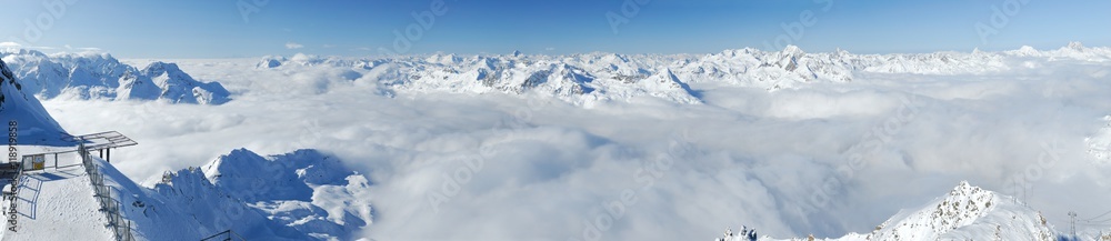 Winter mountains panoramic view with clouds in the valley. Corvatsch, Engadin, Switzerland.