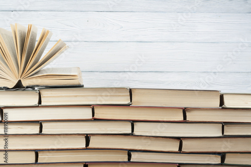 Open book, hardback books on wooden table. Education background. Back to school. Copy space for text.