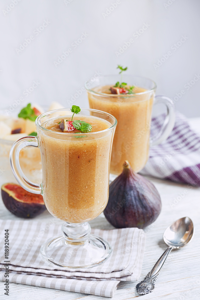 A delicious fresh melon and fig smoothie in a glass with a slice