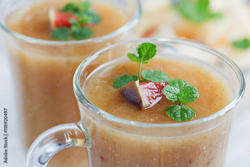 A delicious fresh melon and fig smoothie in a glass with a slice A delicious fresh melon and fig smoothie in a glass with a slice