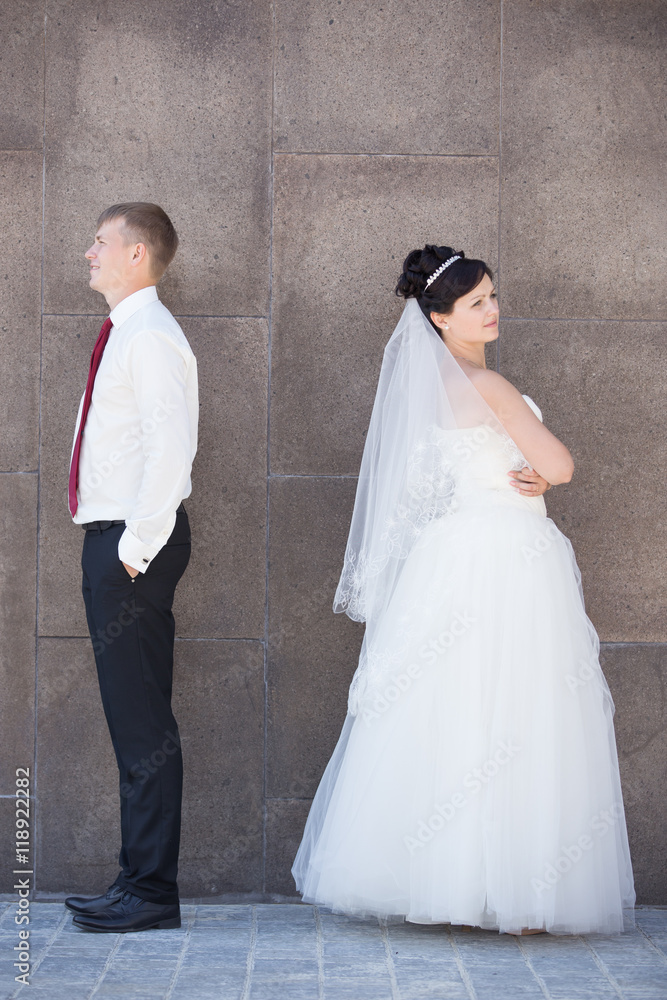 Unhappy newlyweds argue, having relationship difficulties. Marital problems concept. Couple after an argument ignoring each other. Side view portrait Unhappy newlyweds argue, having relationship difficulties. Marital problems concept. Couple after an argument ignoring each other. Side view portrait