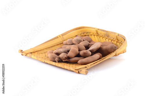 Tamarind isolated on white background in wooden basket. Sweet tamarind (Tamarind indica L.) photo