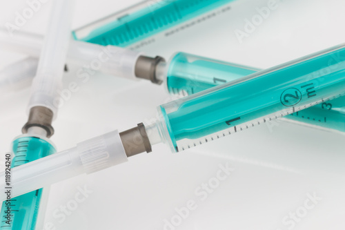 plenty of syringes on white background low focus