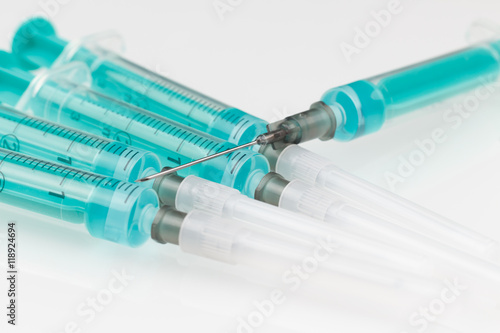 pile of syringes on white background low focus