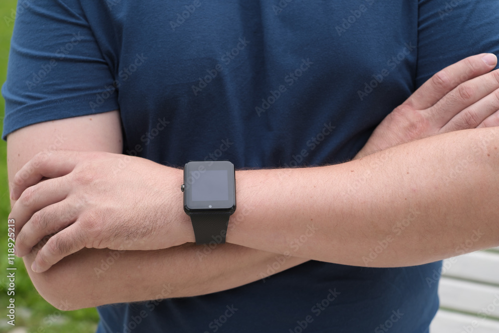 Man using smart watch outdoors Man using smart watch outdoors