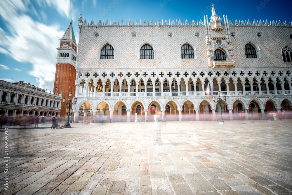 View on San Marco campanille and Doges palace in the center of Venice. Long exposure image technic with motion blurred people
