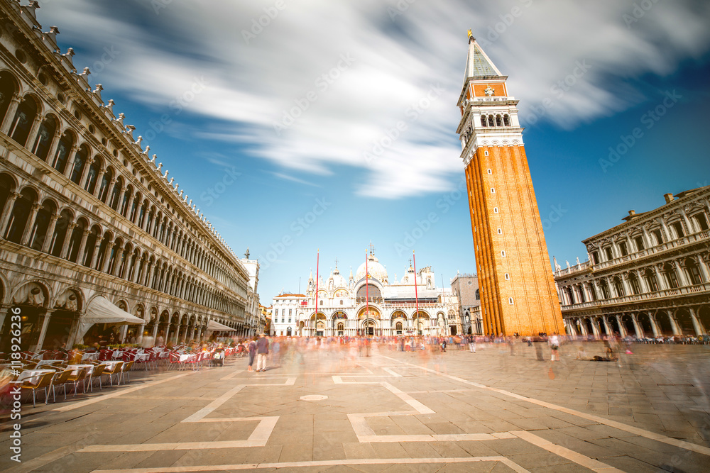 Saint Mark's square with campanille and basilica in Venice. Long exposure image technic with motion blurred people