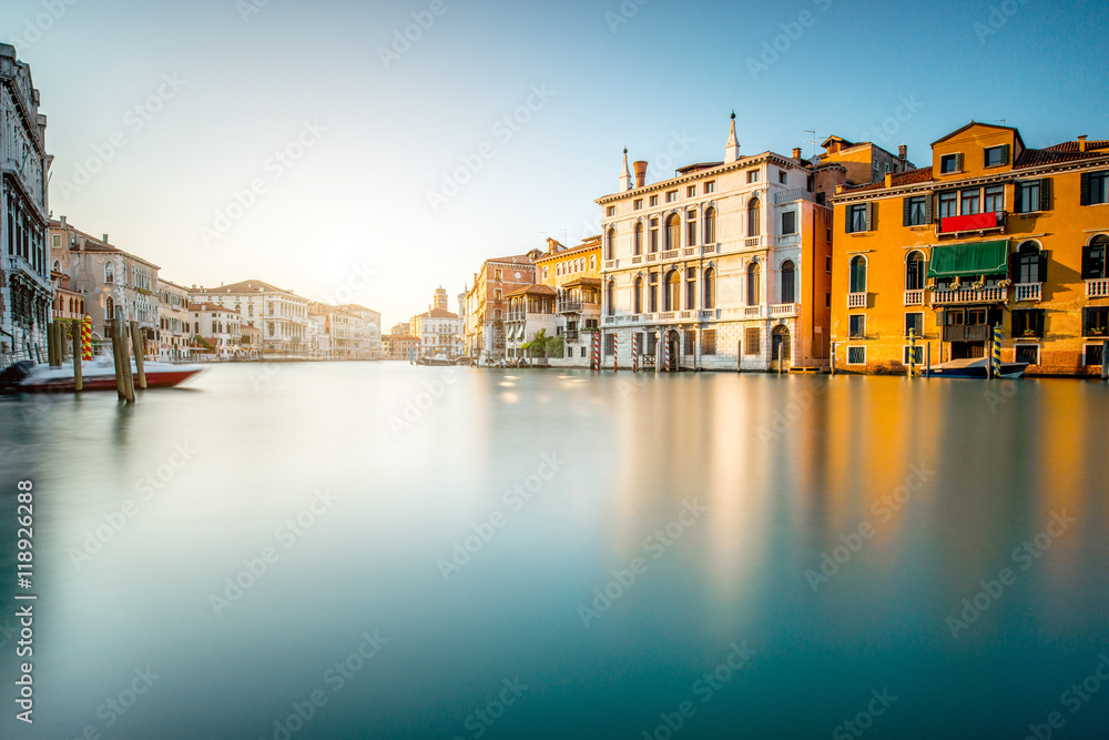 Venice cityscape view on Grand canal with colorful buildings and boats. Long exposure image technic with glossy water