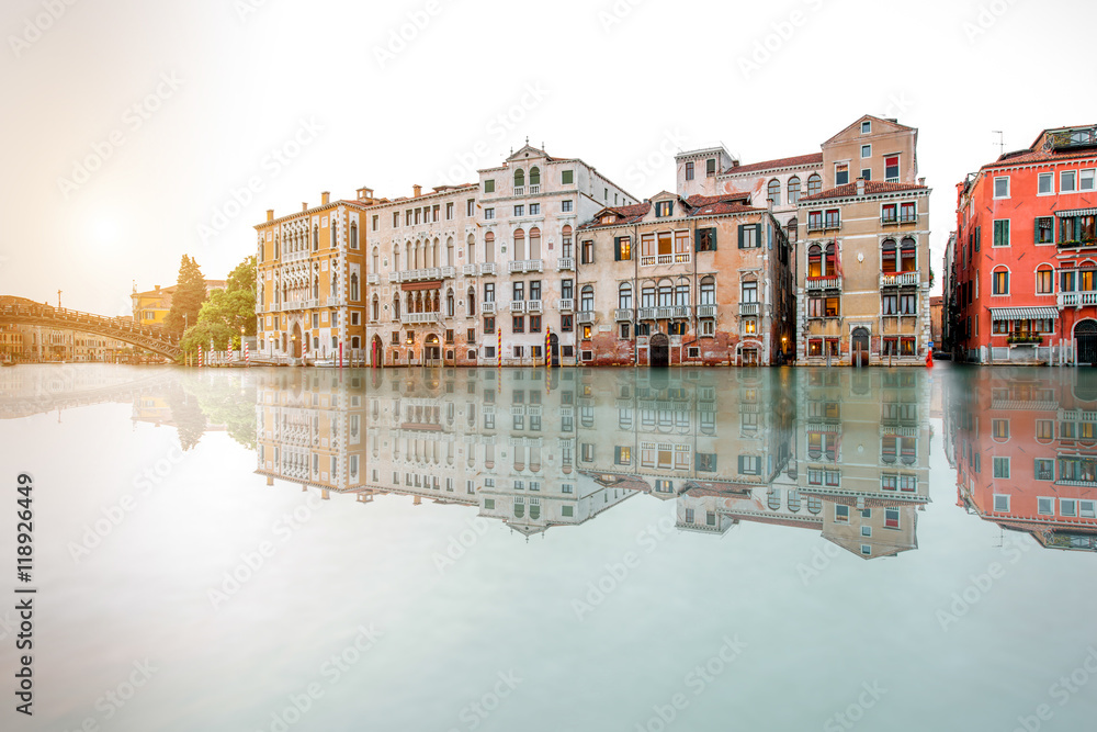 Obraz premium Venice cityscape view on Grand canal with beautiful buildings on the sunset. Long exposure image technic with reflection on the water