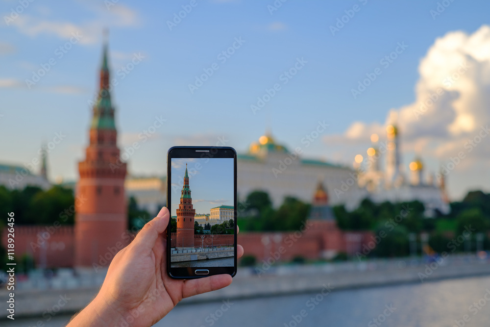 Naklejka premium Man taking picture of Moscow Kremlin landmarks