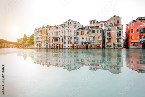 Venice cityscape view on Grand canal with beautiful buildings on the sunset. Long exposure image technic with reflection on the water