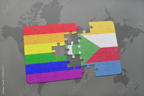 puzzle with the national flag of comoros and gay rainbow flag on a world map background.