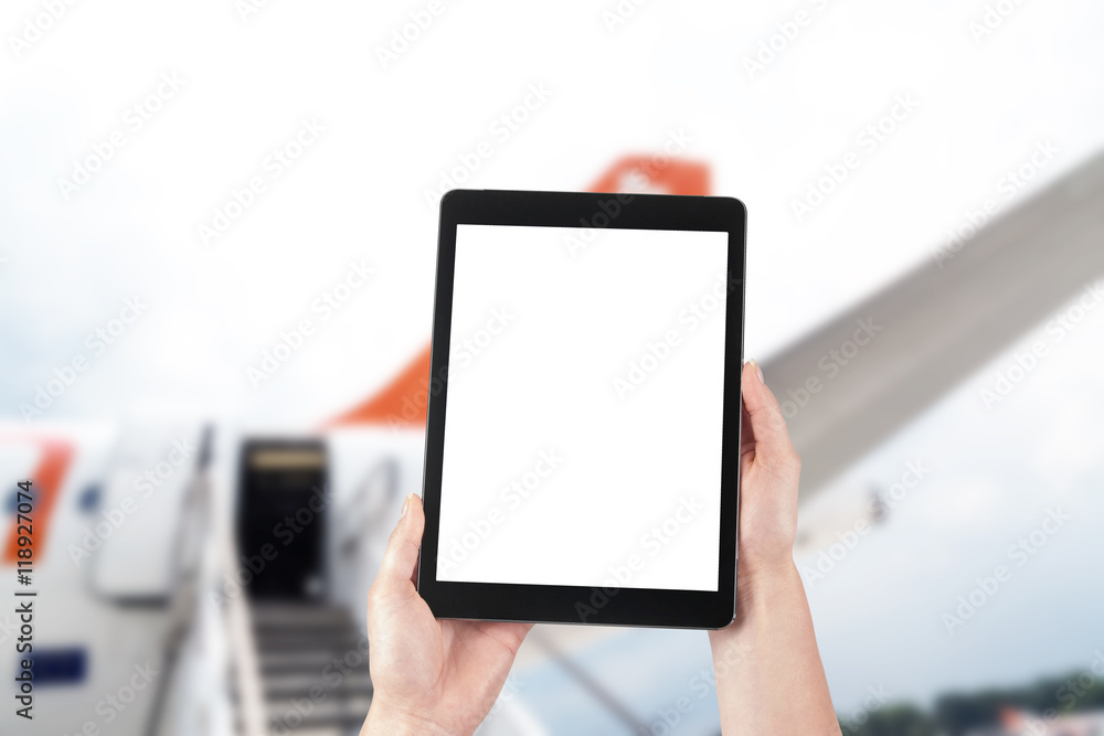 tablet with blank screen for copy and airplane in background