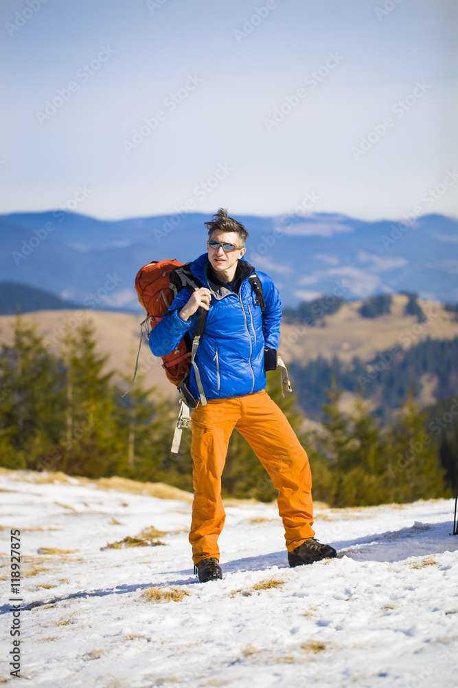 Portrait of mountaineer with mountains in the background.