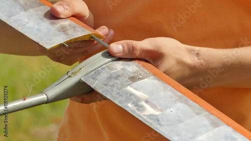 Boy's Hands Are Assembling a Wing of Aircraft Model People at Aircraft Models Competition Outdoors Konotop Ukraine Preparation For Airplane Launch Sunny photo